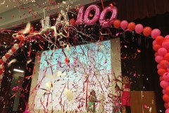 Anniversary-themed-stage-decor-classic-balloon-column-with-string-of-pearls-helium-filled-balloon-arch-with-letters-and-numbers-arch