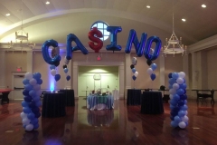 Casino-themed-balloon-column-and-letter-arch