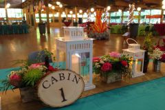 Camping-themed-mitzvah-table-scape-close-up-lanterns-custom-table-numbers-floral