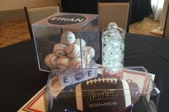 Sports-themed-centerpiece-display-case-with-baseballs-footballs-glass-cylinder-light-orbs